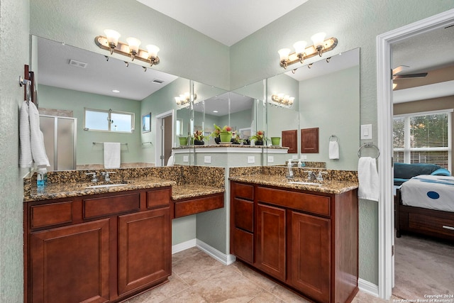 bathroom with tile patterned floors, ceiling fan, an enclosed shower, and vanity