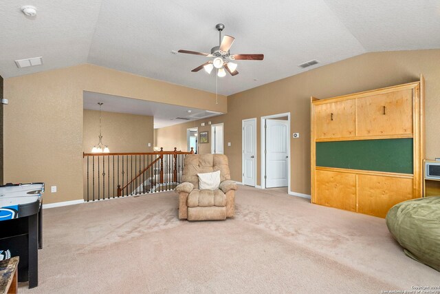 sitting room with carpet, ceiling fan with notable chandelier, and lofted ceiling