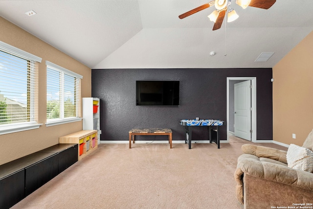 recreation room with ceiling fan, light carpet, and vaulted ceiling