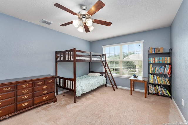 bedroom featuring ceiling fan and light carpet