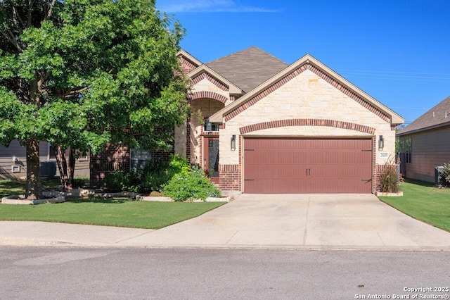 view of front of home with a front yard and a garage