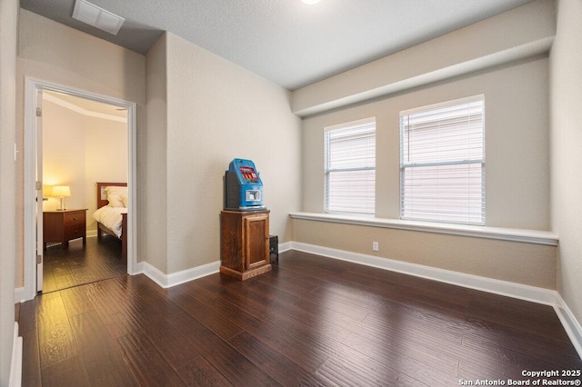 spare room with dark wood-type flooring