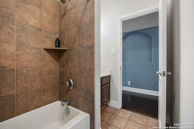 bathroom featuring vanity, tile patterned floors, and tiled shower / bath combo