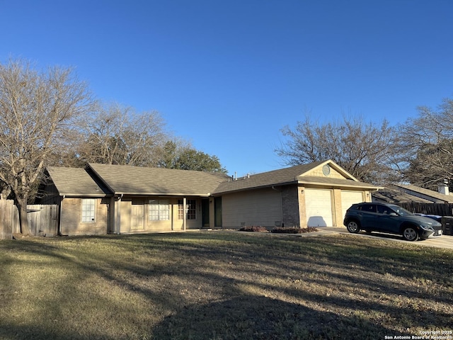 view of front of house with a garage and a front lawn