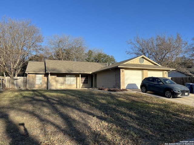 ranch-style house with a garage and a front lawn