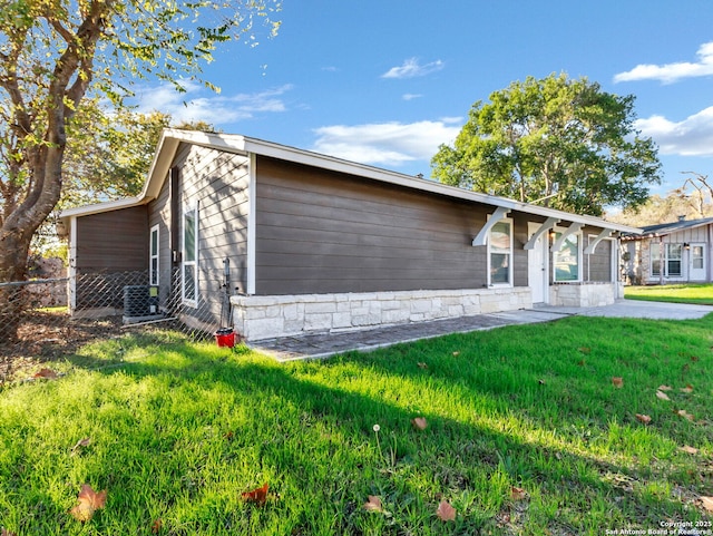 rear view of property featuring a yard