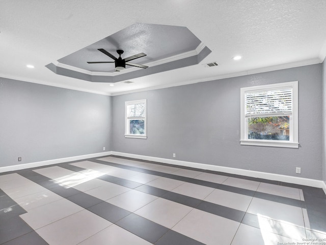 unfurnished room featuring a tray ceiling, ceiling fan, and crown molding