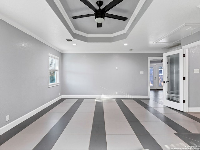 spare room with ceiling fan, a raised ceiling, crown molding, and french doors