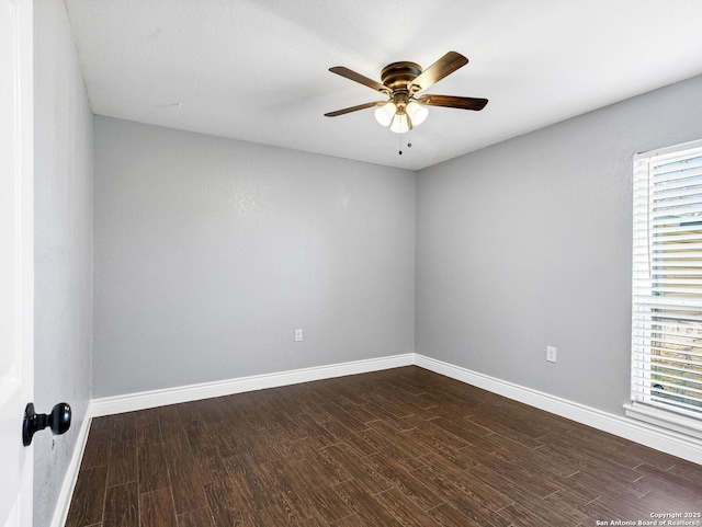 spare room featuring ceiling fan and dark hardwood / wood-style flooring