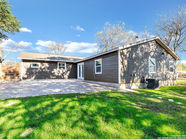 back of house featuring a patio, cooling unit, and a lawn