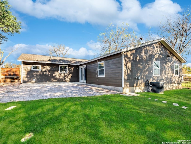 back of house featuring a lawn, a patio, and central AC unit