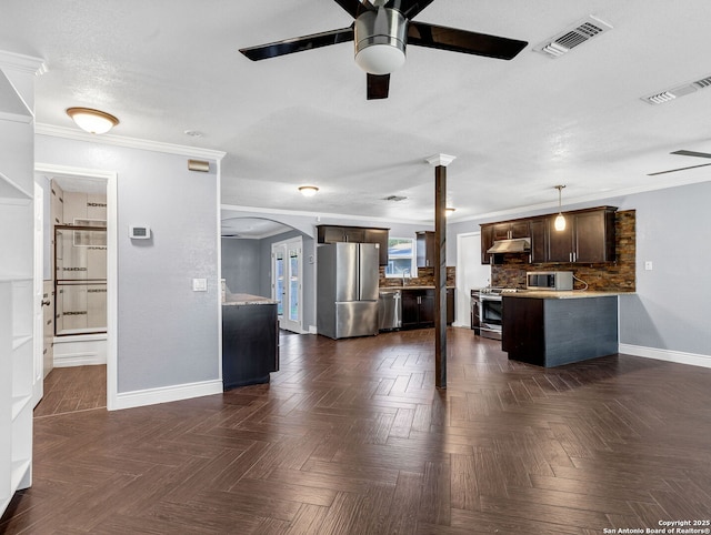 kitchen with dark brown cabinets, dark parquet flooring, appliances with stainless steel finishes, and tasteful backsplash