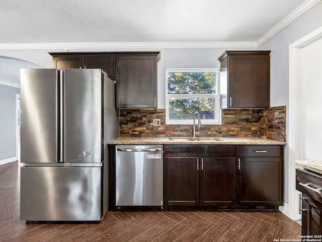 kitchen featuring light stone counters, sink, stainless steel appliances, and dark parquet flooring