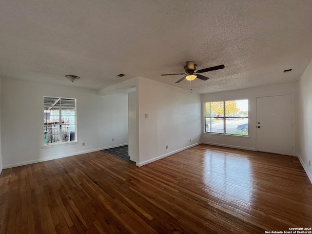 spare room featuring a textured ceiling, dark hardwood / wood-style flooring, and ceiling fan