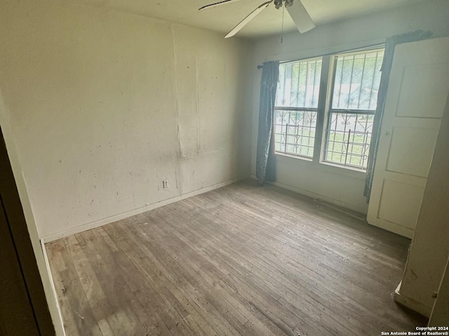 empty room featuring ceiling fan and wood-type flooring