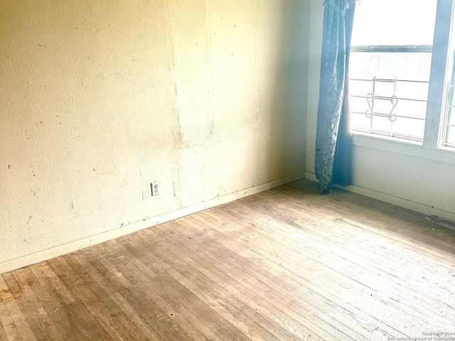 unfurnished room featuring hardwood / wood-style floors