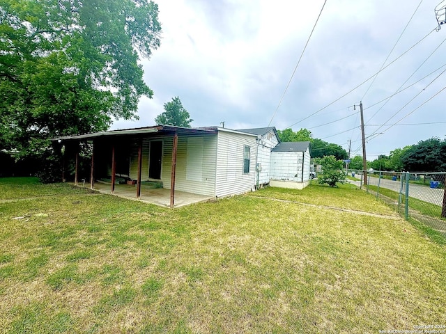 back of property with a patio area and a lawn