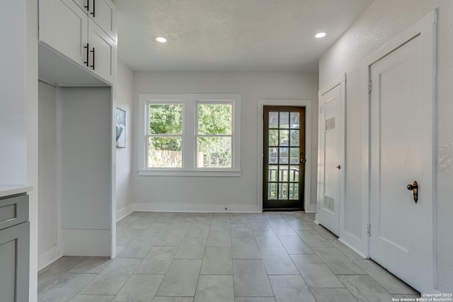 entryway with a textured ceiling