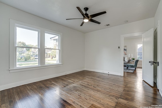 unfurnished room with ceiling fan and dark wood-type flooring