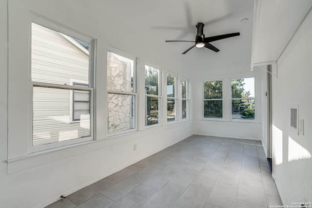 unfurnished sunroom featuring ceiling fan