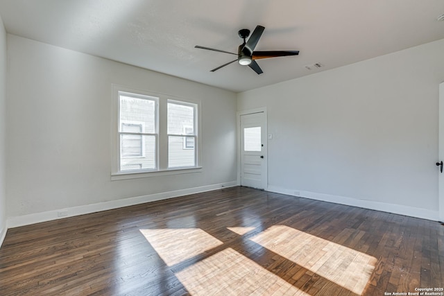 spare room featuring dark hardwood / wood-style floors and ceiling fan