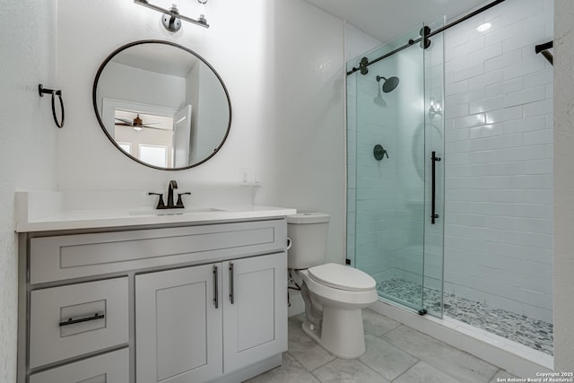 bathroom featuring ceiling fan, toilet, walk in shower, and vanity