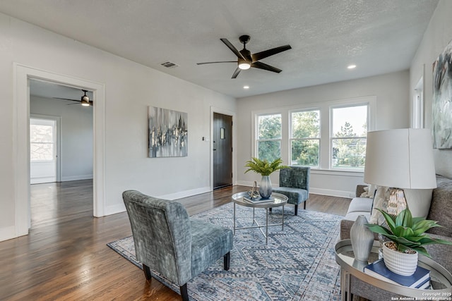 living room with dark hardwood / wood-style floors and a textured ceiling