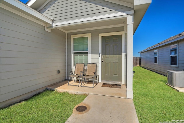 property entrance with a lawn, central AC, and covered porch