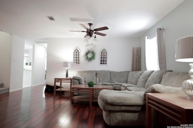 living room featuring ceiling fan and dark hardwood / wood-style flooring