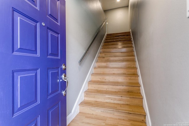 stairway with hardwood / wood-style flooring