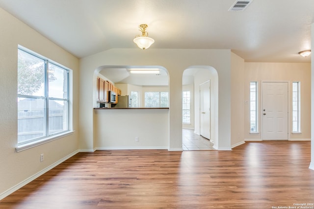 foyer entrance featuring light hardwood / wood-style flooring and lofted ceiling