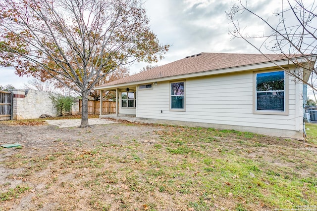 back of house with central AC