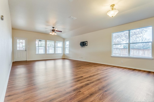 unfurnished living room featuring ceiling fan, dark hardwood / wood-style floors, and lofted ceiling