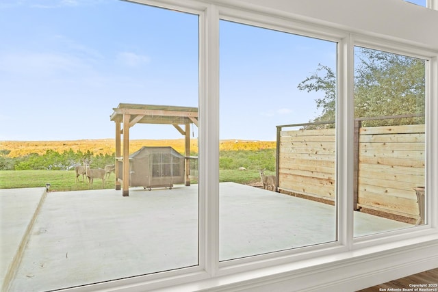 entryway with hardwood / wood-style floors and a rural view