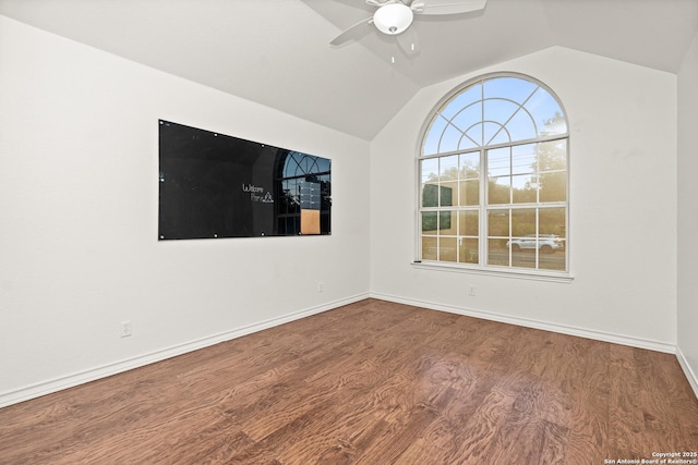 empty room with ceiling fan, vaulted ceiling, and hardwood / wood-style flooring