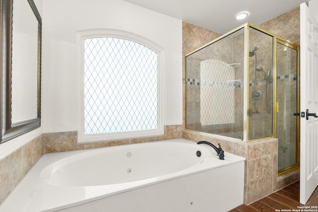 bathroom featuring shower with separate bathtub