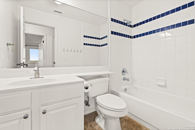 full bathroom featuring tiled shower / bath combo, toilet, and vanity