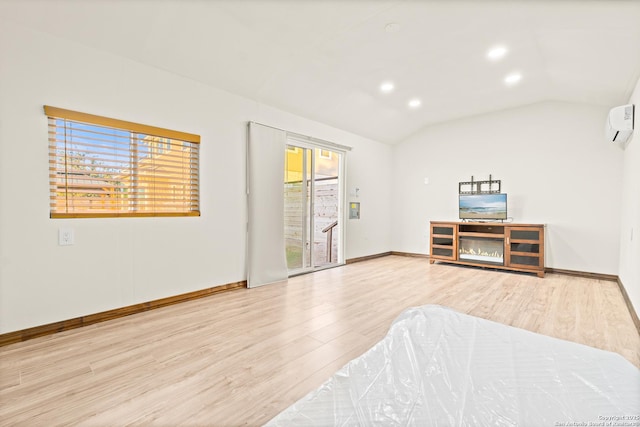 bedroom featuring access to exterior, wood-type flooring, a wall mounted AC, and lofted ceiling