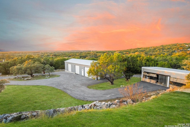 exterior space featuring a yard, a garage, and an outdoor structure