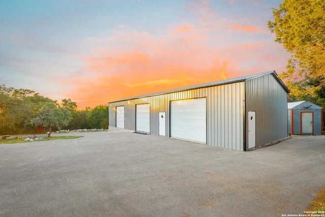 view of garage at dusk