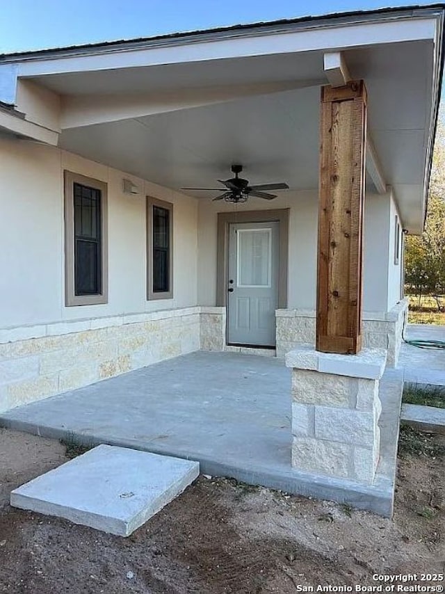 doorway to property with ceiling fan