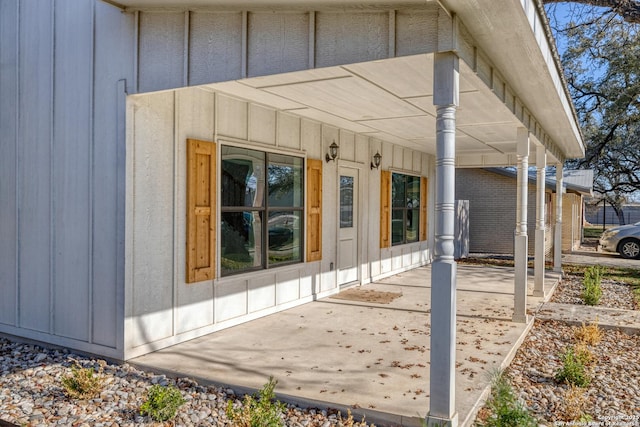 view of exterior entry featuring a patio