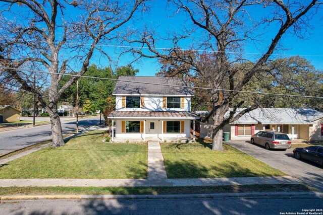 view of front of house with a front yard and a porch