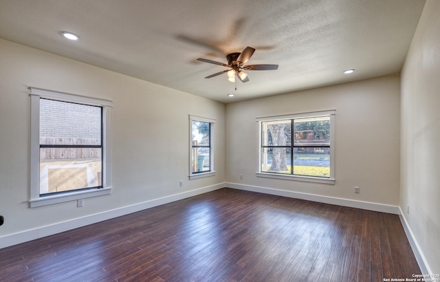 unfurnished room with dark hardwood / wood-style floors and ceiling fan