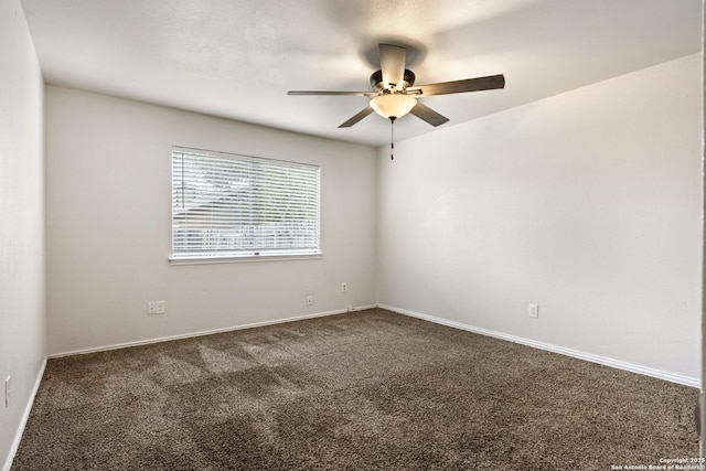 unfurnished room featuring dark colored carpet and ceiling fan