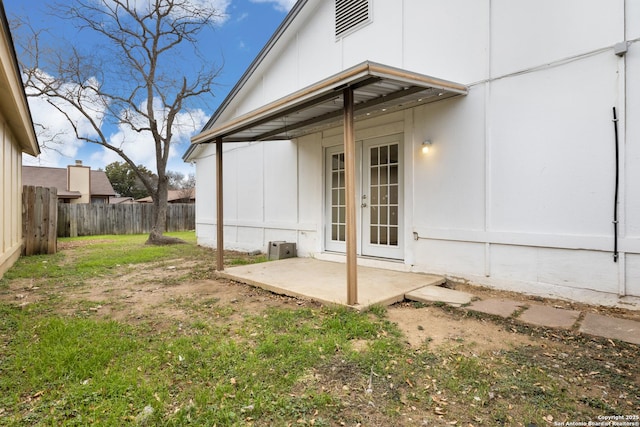 property entrance featuring a patio and french doors