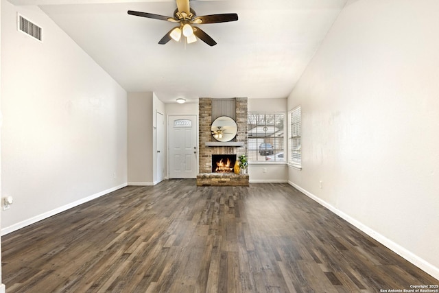 unfurnished living room with ceiling fan, a fireplace, and dark wood-type flooring