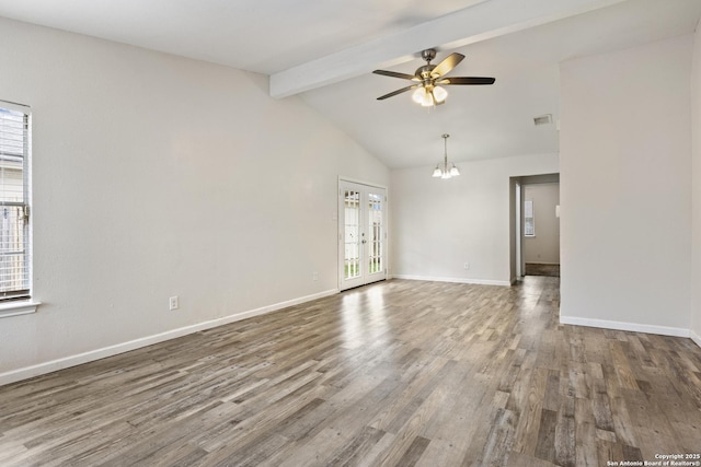 spare room featuring ceiling fan with notable chandelier, hardwood / wood-style floors, lofted ceiling with beams, and french doors