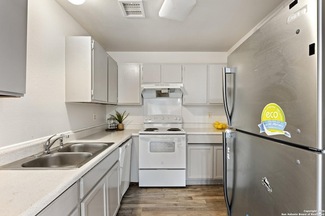 kitchen with sink, wood-type flooring, and white appliances