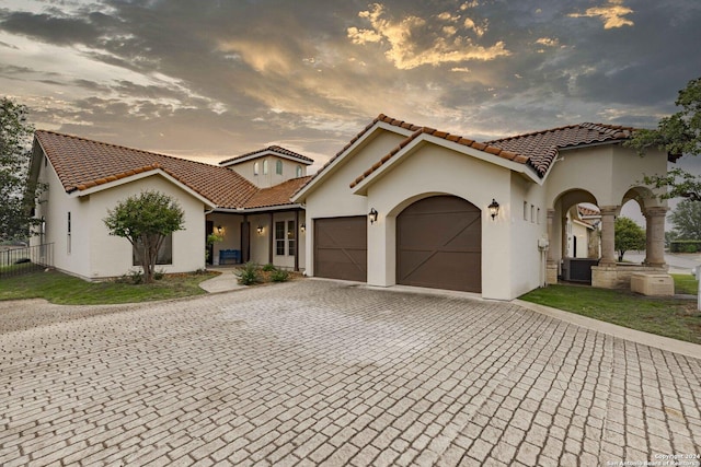 mediterranean / spanish house featuring a garage